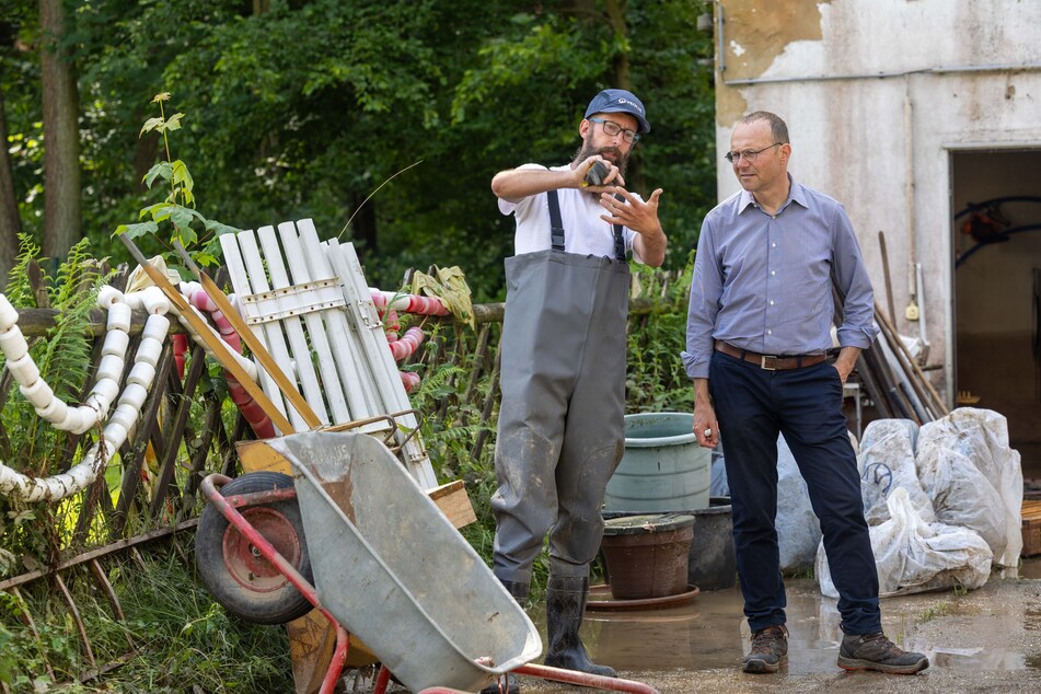 Sebastian Schulze, Leiter vom Waldbad, spricht mit Sachsens Umweltminister Wolfram Günther (50, Bündnis 90/Die Grünen, r.) über die Schäden in Colditz.