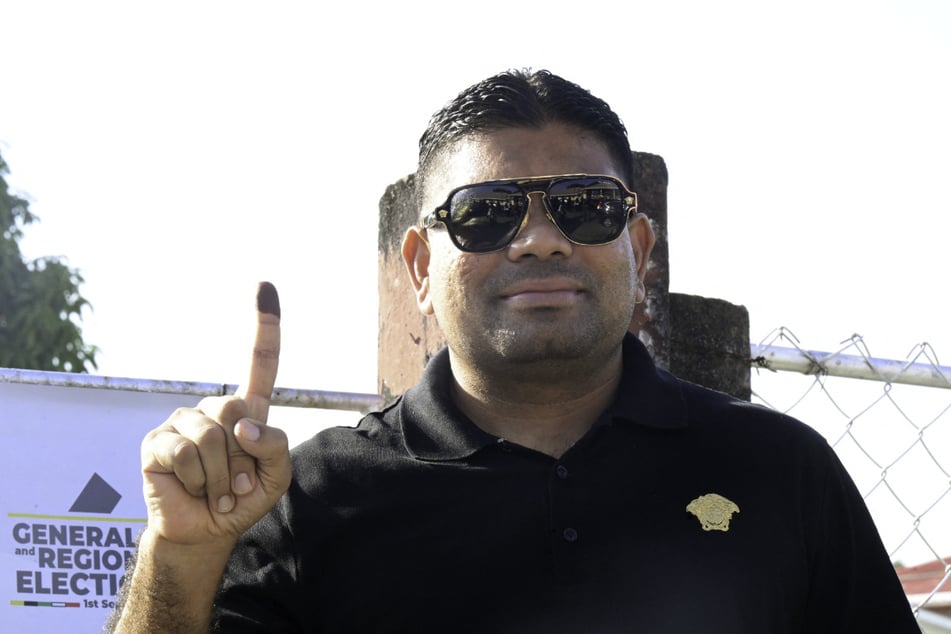 Guyanese presidential candidate Azruddin Mohamed from the WIN party gestures to the media after voting at a polling station during the election in Georgetown on September 1, 2025.