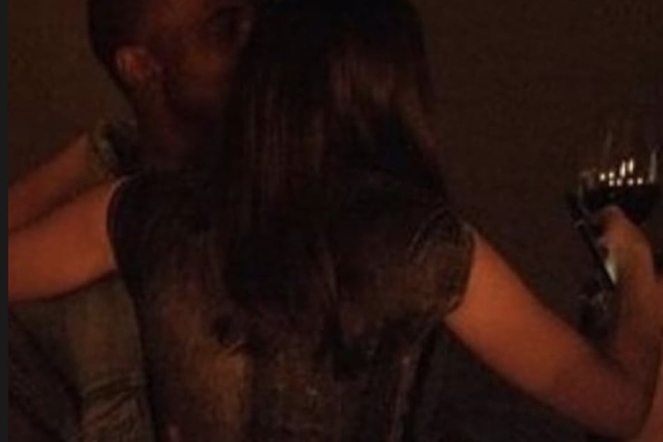Julia Fox and Kanye "Ye" West shared a kiss while the actor held a glass of wine in one of the shots.