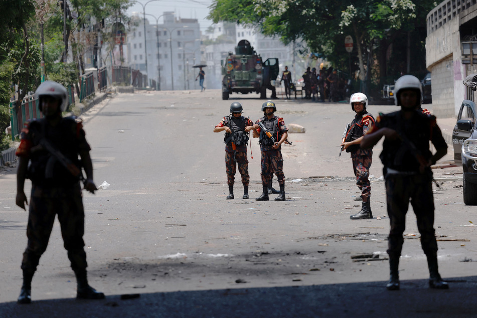 Members of Border Guard Bangladesh stand guard outside the state-owned Bangladesh Television in Dhaka amid anti-quota protests by students.