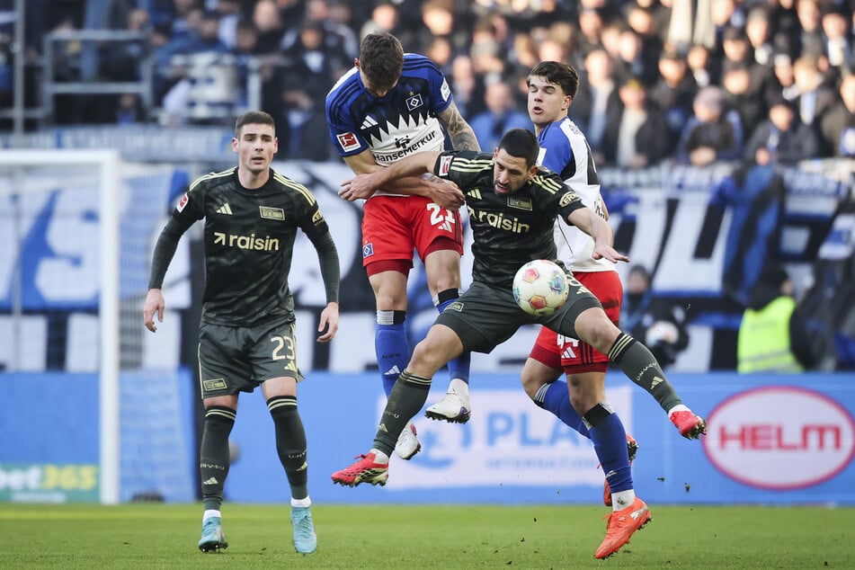 Rani Khedira (1. FC Union Berlin, m.) behauptet sich im Zweikampf gegen Luka Vušković (Hamburger SV, r.) und Nicolai Remberg (Hamburger SV).