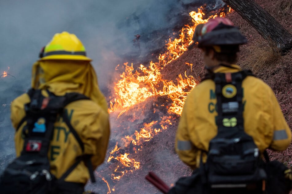 Firefighters respond as the Palisades Fire burns at the Mandeville Canyon, a neighborhood of Los Angeles, California, on January 11, 2025.