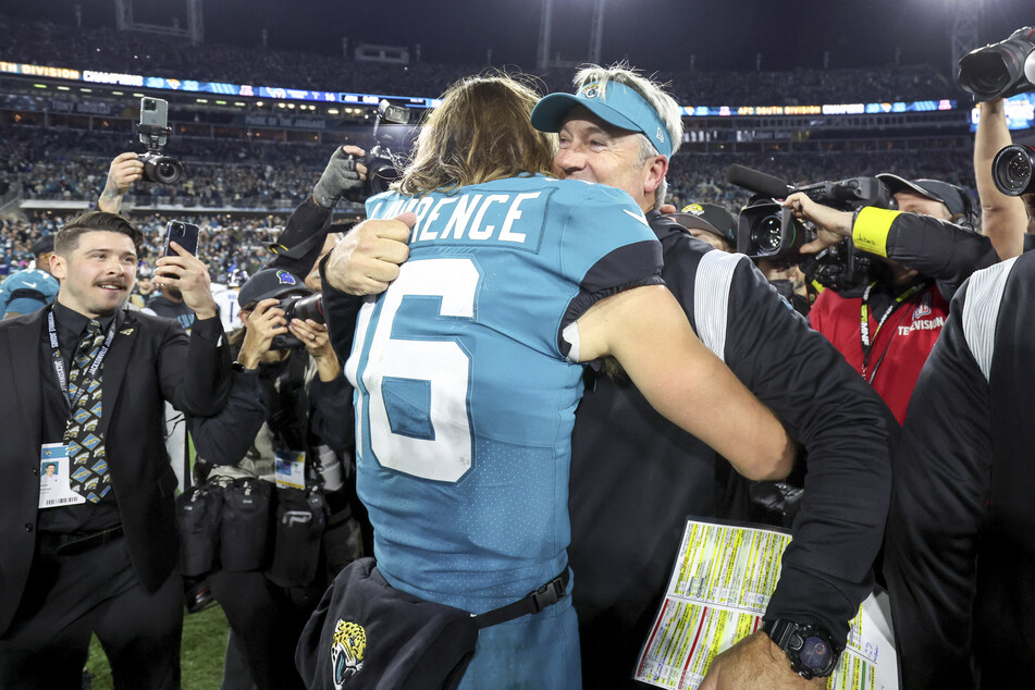Head coach Doug Pederson of the Jacksonville Jaguars hugs his quarterback Trevor Lawrence after their 20-16 win over the Tennessee Titans.