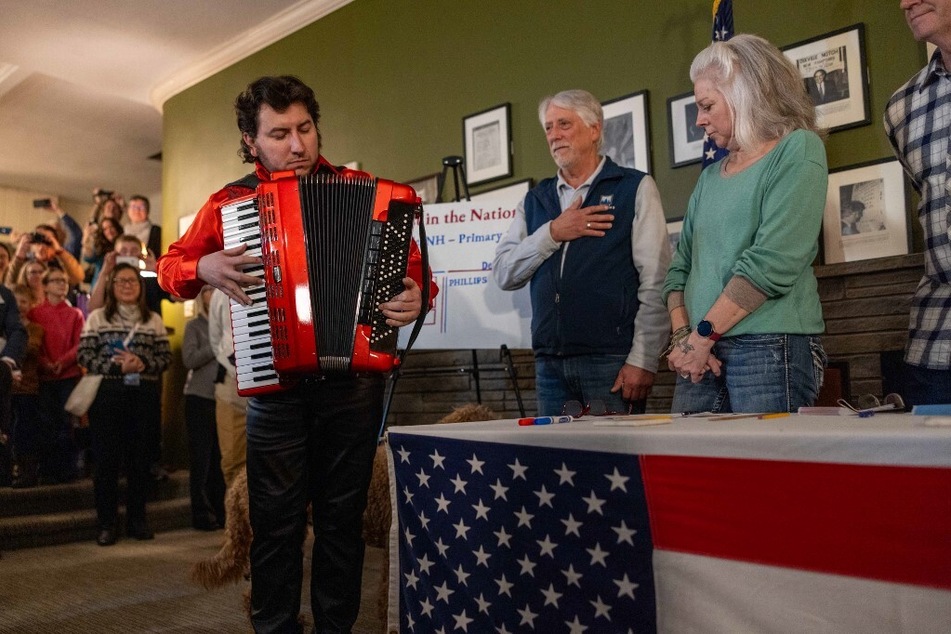 Cory "C Pez" Pesaturo, a US National Accordion Champion, plays the national anthem just before midnight on January 22, 2024, in Dixville Notch, New Hampshire, as voters prepare to cast their ballots in the presidential primary.