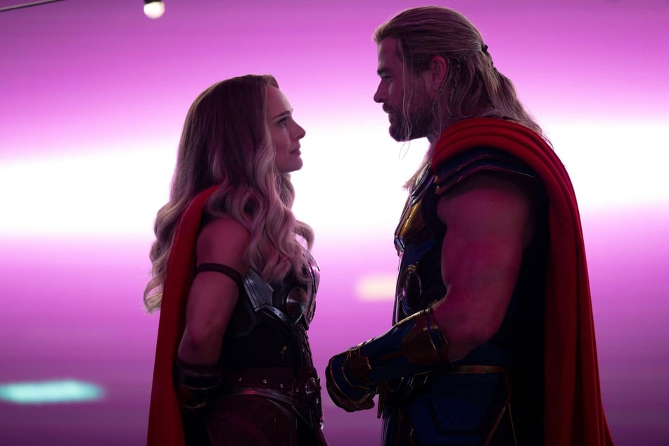Chris Hemsworth (r) dished on his nude scene in Thor: Love and Thunder that was apparently "years in the making."