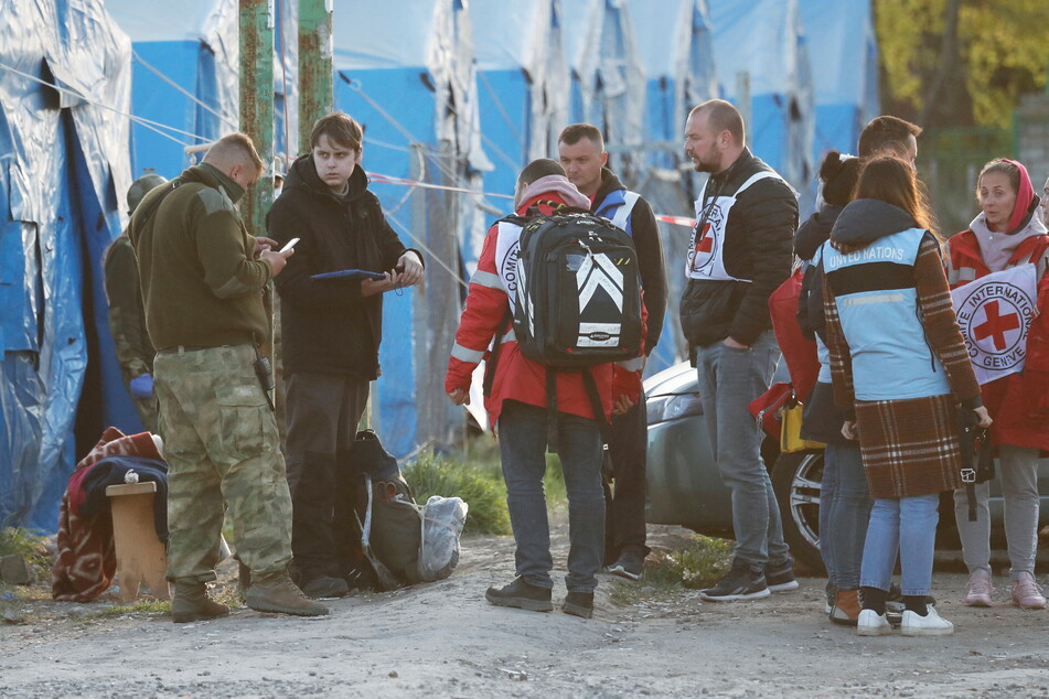 Evacuees from the Azovstal steel plant arrive at a temporary accommodation center in Bezimenne.