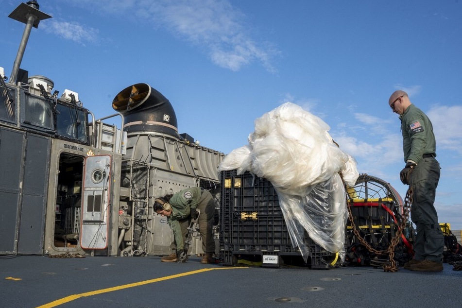 US Navy sailors assigned to Assault Craft Unit 4 prepare material recovered in the Atlantic Ocean from a high-altitude balloon for transport to federal agents at Joint Expeditionary Base Little Creek.