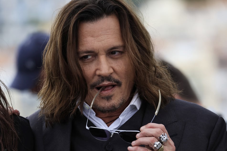 Johnny Depp (r.) appears at the 76th Cannes Film Festival.