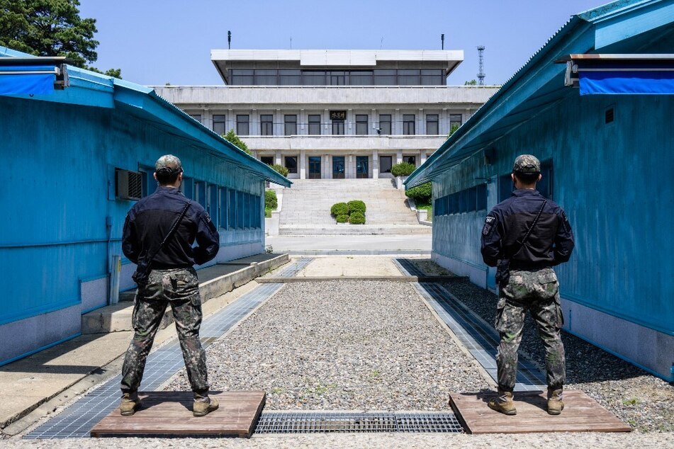 South Korean soldiers stand guard as they face North Korea's Panmon Hall at the truce village of Panmunjom in the Joint Security Area of the Demilitarized Zone.