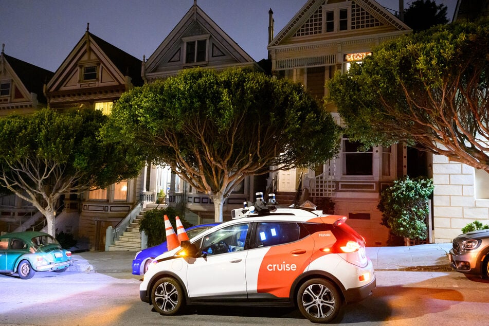 Members of SafeStreetRebel, a group of anonymous anti-car activists, placed traffic cones on a self-driving robotaxi to disable it in San Francisco, California on July 11, 2023.