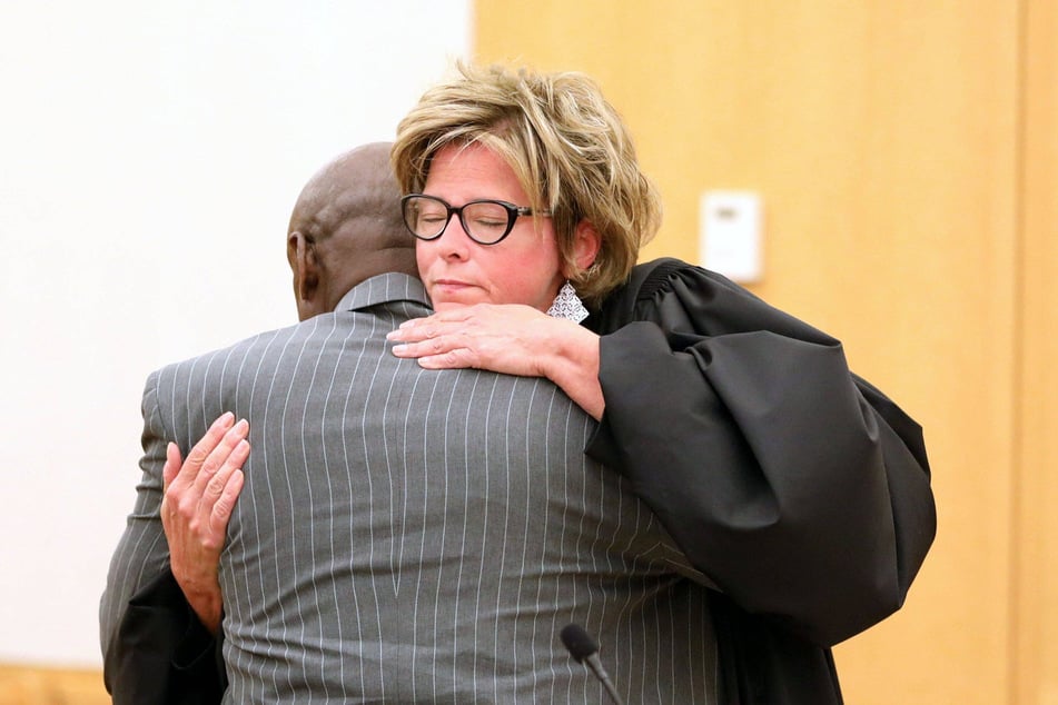 Supreme Court Justice Anne Minihan and Leonard Mack hugging after the reversal of his wrongful rape conviction.