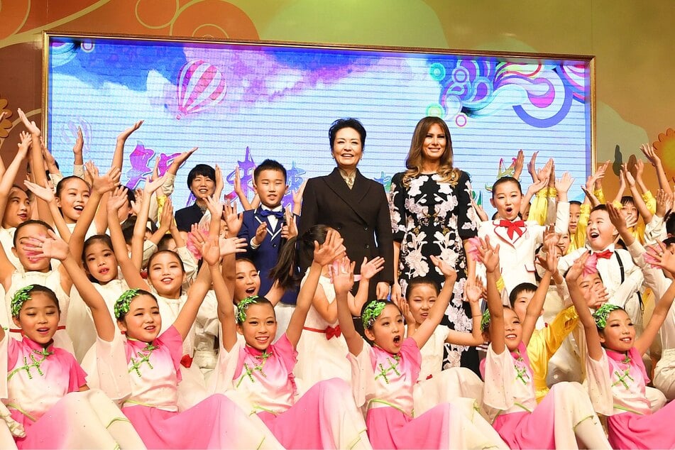 First Lady Melania Trump (center r.) has reportedly become an internet sensation in China as she continues struggling to connect with the American people.