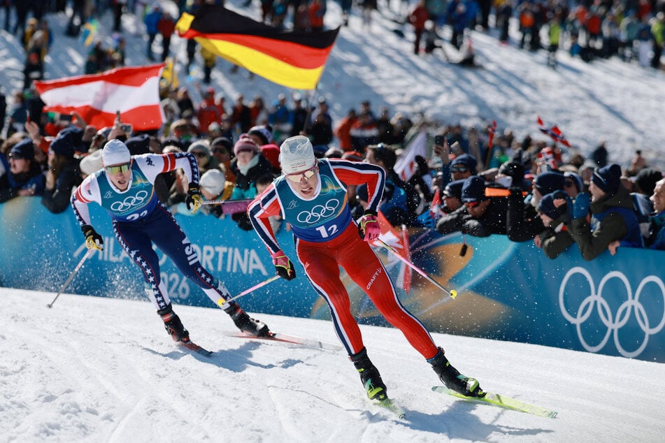 Johannes Hoesflot Klaebo of Norway and Gus Schumacher of the US in action during the Men's Team Sprint Free Final at the Milan Cortina Olympics on February 18, 2026.