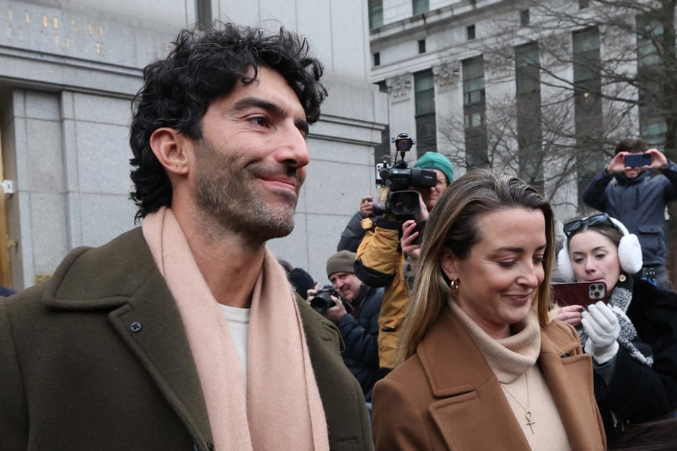 Schauspieler und Regisseur Justin Baldoni (42) Hand in Hand mit seiner Frau Emily Baldoni (41) bei einem Gerichtstermin im Februar 2026.