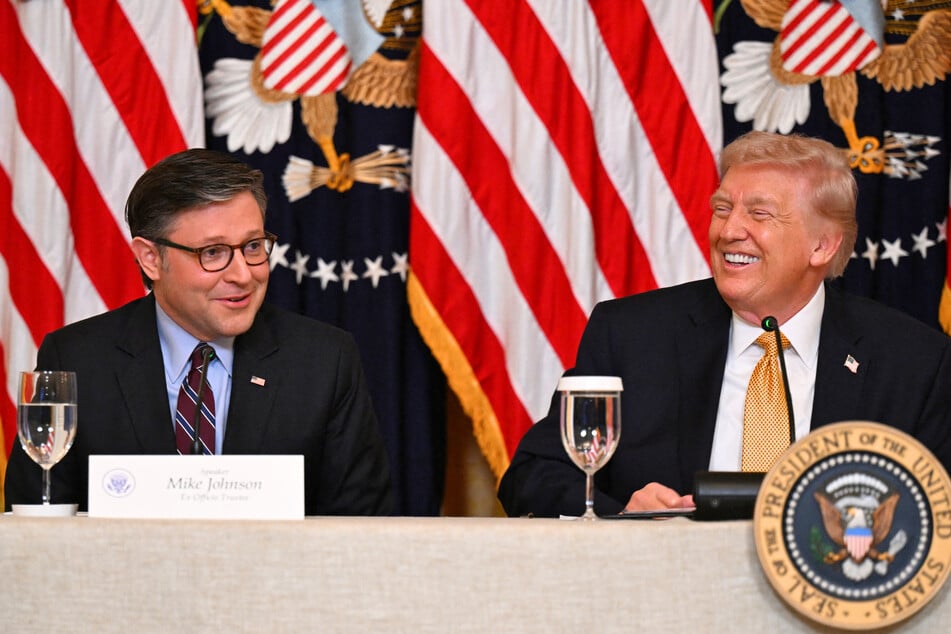 President Donald Trump (r.) smiles as House Speaker Mike Johnson speaks during a lunch at the White House on March 16, 2026.