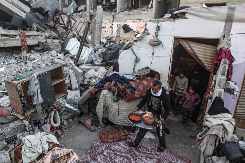 Members of the Rabaya family amidst the rubble of their home, which was destroyed by an Israeli strike, in Rafah on Saturday.