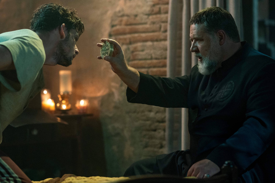 Russell Crowe (r) defends his faith while battling the ultimate evil as priest and exorcist Gabriele Amorth in the upcoming horror film, The Pope's Exorcist.