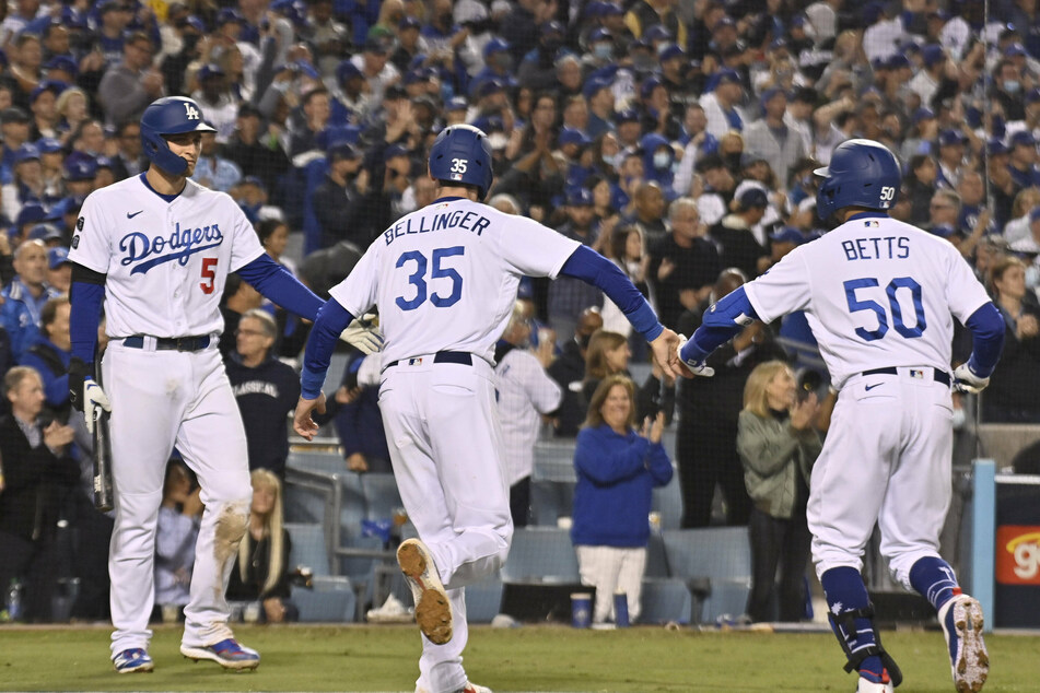 Cody Bellinger (c), Mookie Betts (r) and Corey Seager (l) celebrate as the Dodgers force game five of the NLDS on Thursday night.