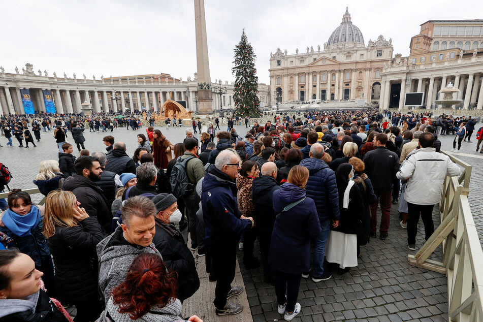 People queue to enter St. Peter’s Basilica to pay homage to former Pope Benedict XVI on January 2, 2023.