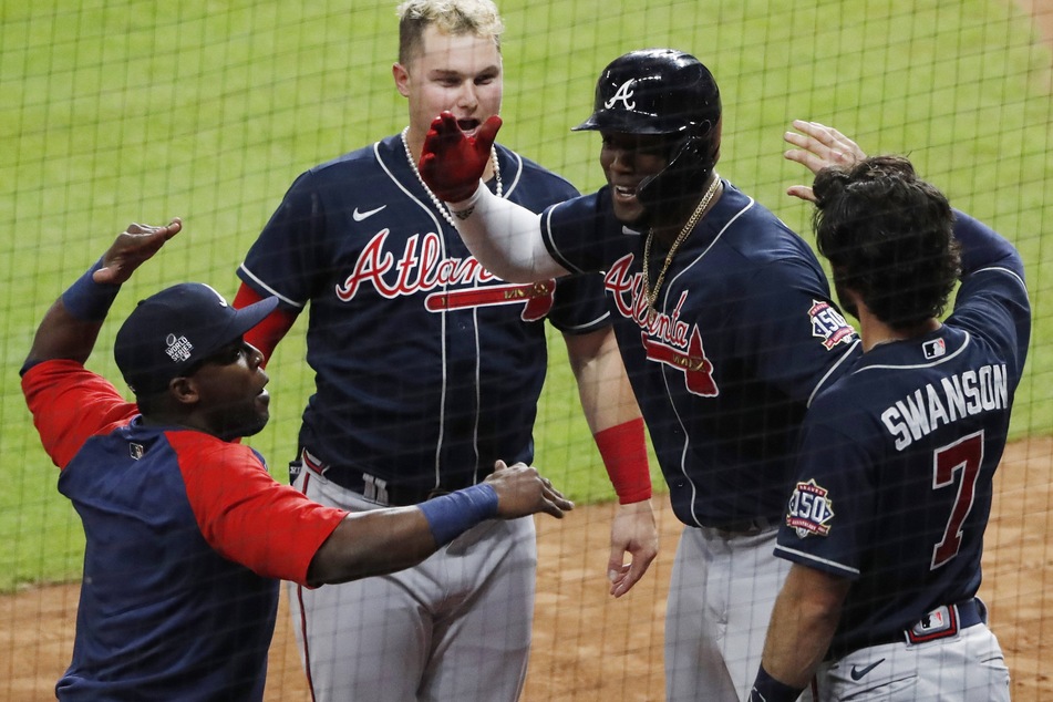 Braves lead off batter Jorge Soler celebrates with teammates after hitting a solo home run in the 1st inning.