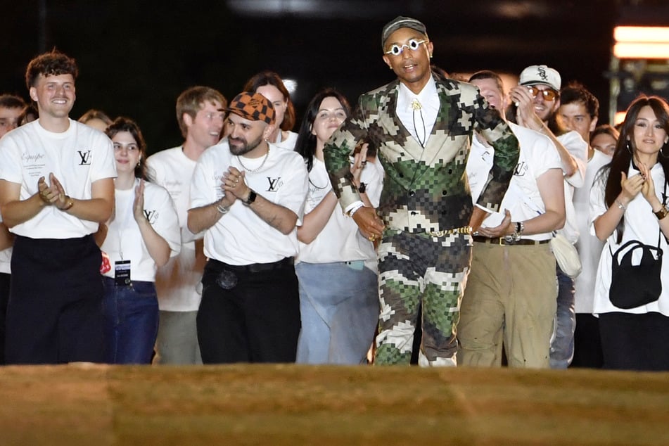 Several A-list attendees matched Pharrell Williams' pixelated suit at his debut as Louis Vuitton's menswear creative director on Tuesday.