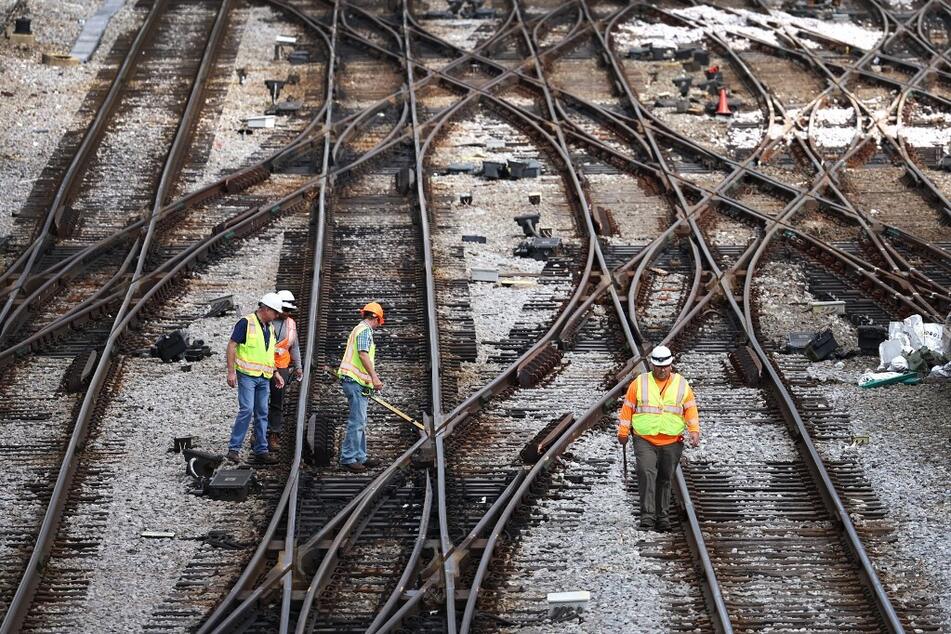 Workers service the tracks at the Metra/BNSF railroad yard in Chicago, Illinois.