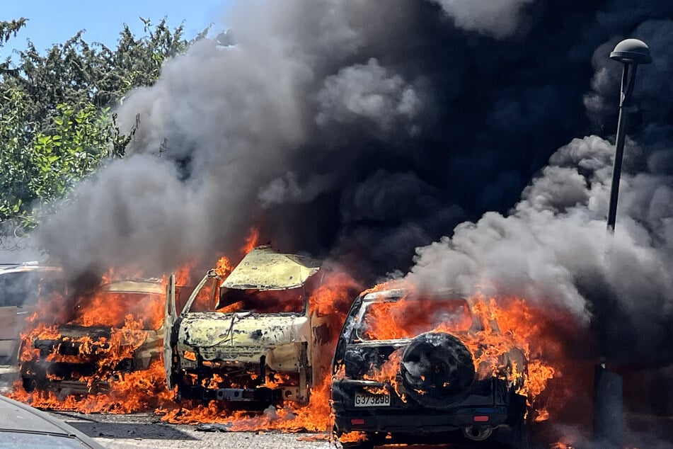 Vehicles are engulfed in flames and smoke following an Israeli airstrike on southern Lebanon last week.