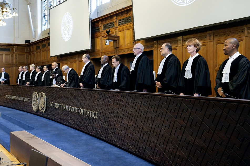 (From R) South African Judge Dire Tladi, US Judge Sarah Cleveland, Brazilian Judge Leonardo Nemer Caldeira Brant, German Judge Georg Nolte, Idian Judge Dalveer Bhandari, Somali Judge Abdulqawi Yusuf, Slovak Judge Peter Tomka, Lebanese Judge and President of the International Court of Justice (ICJ) Nawaf Salam, Ugandan Judge and Vice-President of the International Court of Justice Julia Sebutinde, French Judge Ronny Abraham, Chinese Judge Xue Hanqin, Japanese Judge Yuji Iwasawa, Australian Judge Hilary Charlesworth, Mexican Judge Juan Manuel Gomez Robledo, Romanian Judge Bogdan Lucian Aurescu rise before delivering a non-binding ruling on the legal consequences of the Israeli occupation of the West Bank and East Jerusalem at the International Court of Justice (ICJ) in The Hague on Friday.