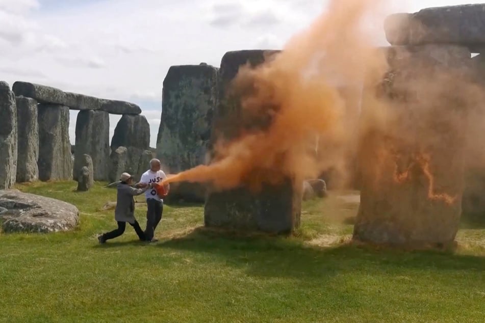 Climate activists spray Stonehenge with orange paint in viral protest