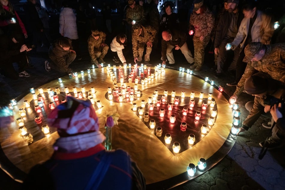People arrange candles in the shape of a radiation sign during a commemoration ceremony marking the 40th anniversary of the explosion at the Chernobyl nuclear power plant in the town of Slavutych, Ukraine, on April 25, 2026,