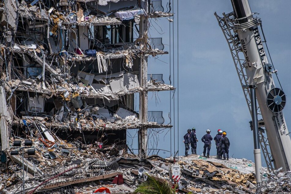 Search and rescue teams look for possible survivors in the partially collapsed 12-story Champlain Towers South condo building on June 27, 2021, in Surfside, Florida.