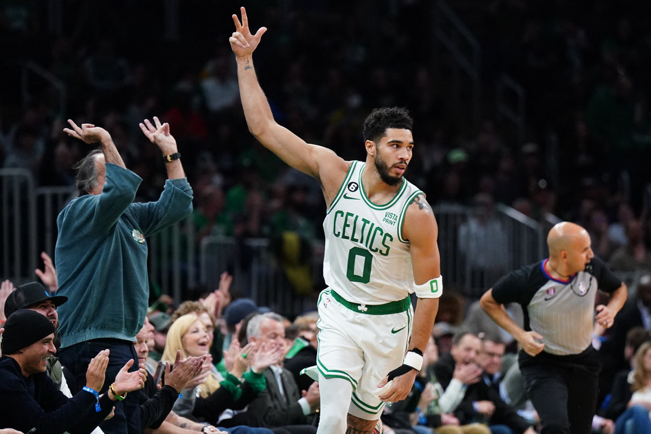 Boston Celtics forward Jayson Tatum reacts after his three point basket against the Miami Heat in the first quarter at TD Garden.