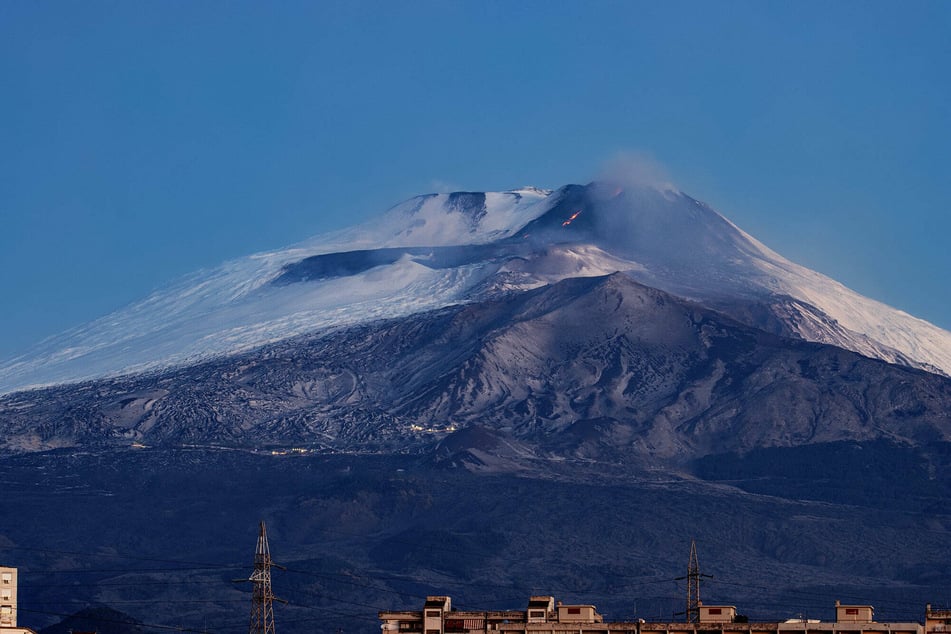 Smoke, lava, and ashes rise from Etna volcano in Sicily, Italy.