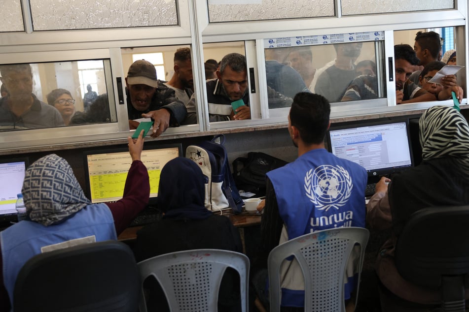 Palestinians wait to receive medicine at the UNRWA Japanese Health Center in Khan Yunis on the southern Gaza Strip on Tuesday, amid the ongoing war between Israel and the Palestinian militant group Hamas.