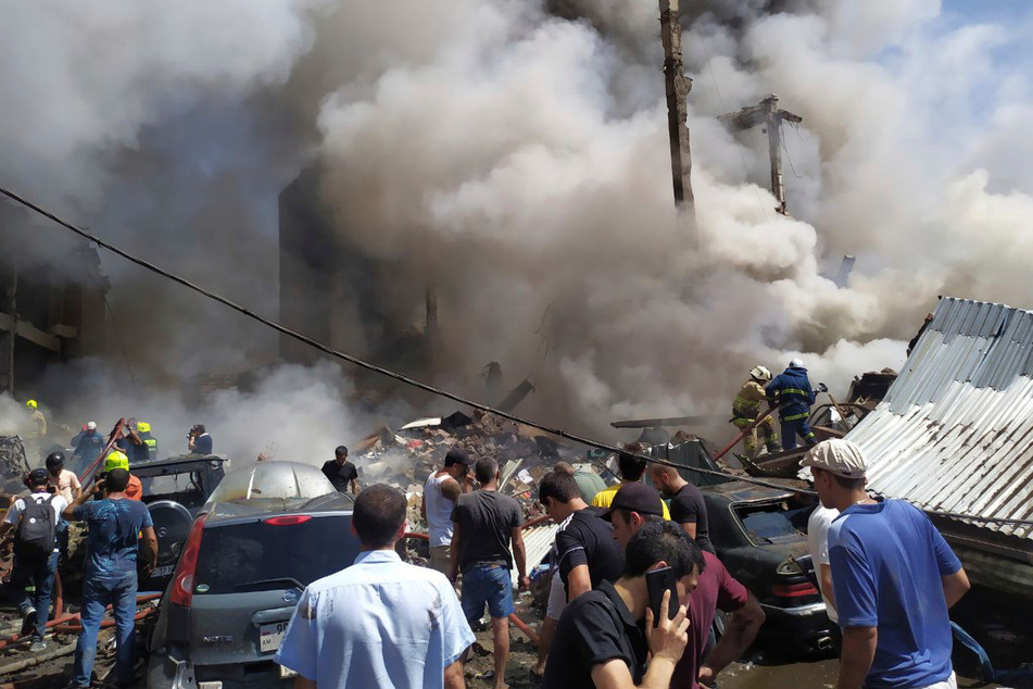 Civilians looked on as firefighters responded to the blaze.