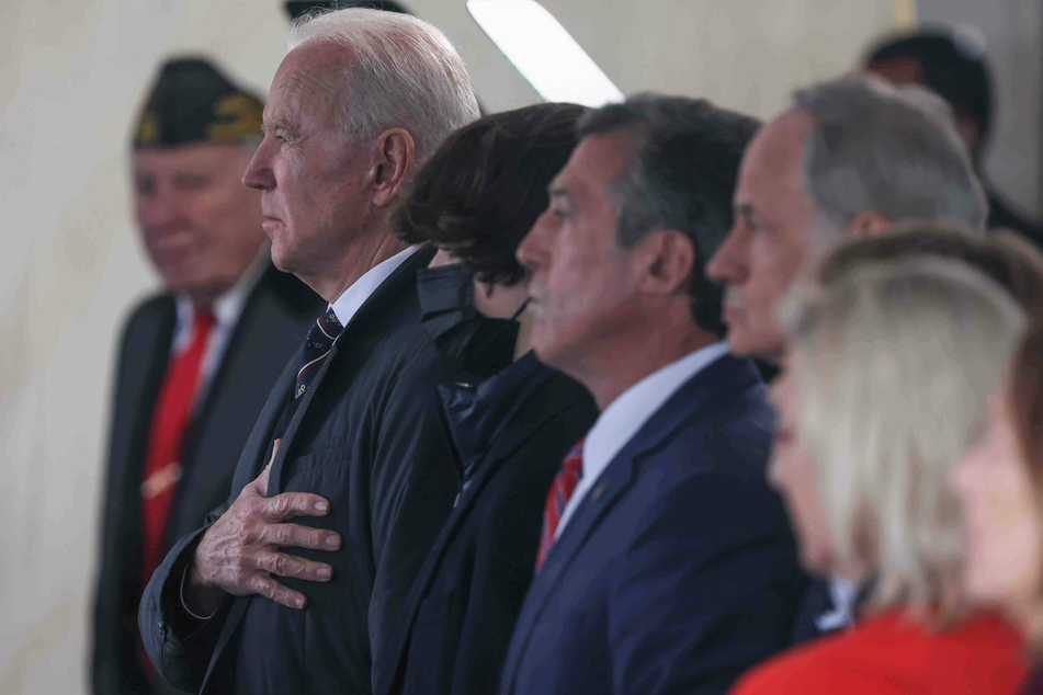 Joe Biden places his hand over his heart for the national anthem during the Memorial Day ceremony at Veterans Memorial Park in New Castle, Delaware.