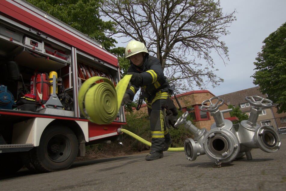 Ein Kamerad bereitet sich auf einen Einsatz vor: Die Freiwillige Feuerwehr Köln führt am Donnerstag eine realistische Lösch-Übung am Deutzer Hafen durch. (Symbolbild)