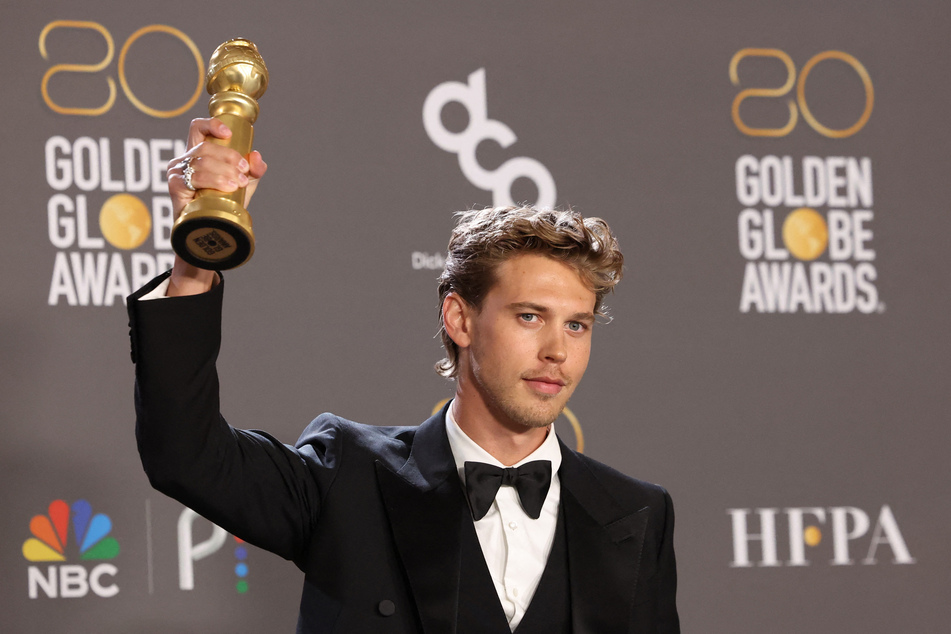 Austin Butler poses with his award for Best Actor in a Drama Motion Picture for "Elvis" at the 80th Annual Golden Globe Awards.