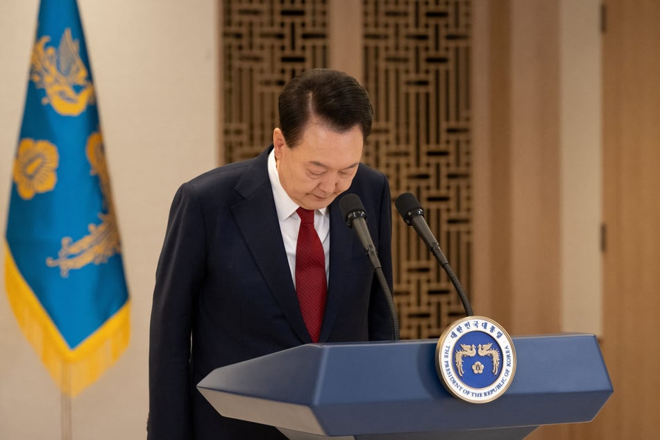 South Korean President Yoon Suk Yeol bows while delivering an address to the nation at the Presidential Office in Seoul on December 12, 2024.