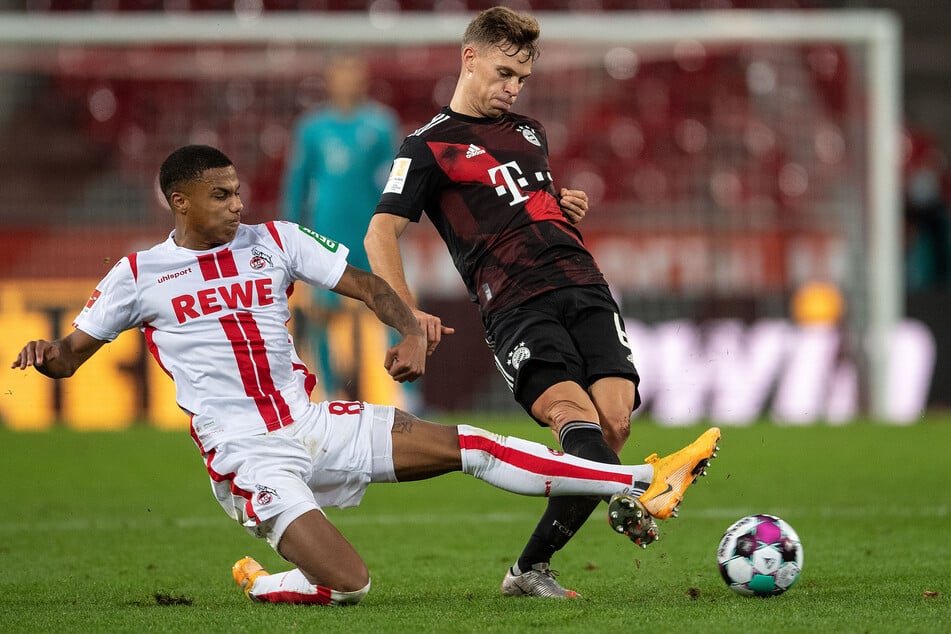 Cologne's Ismail Jakobs (left) and Bayern's Joshua Kimmich fight for the ball.