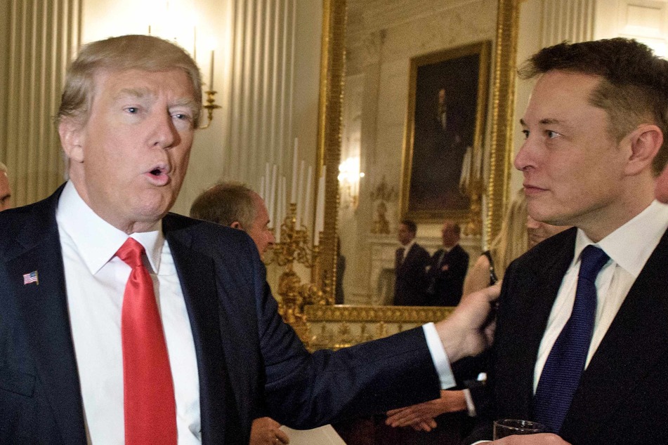 Then-President Donald Trump (l.) greets Elon Musk (r.) before a policy and strategy forum with executives in the State Dining Room of the White House February 3, 2017 in Washington, DC.