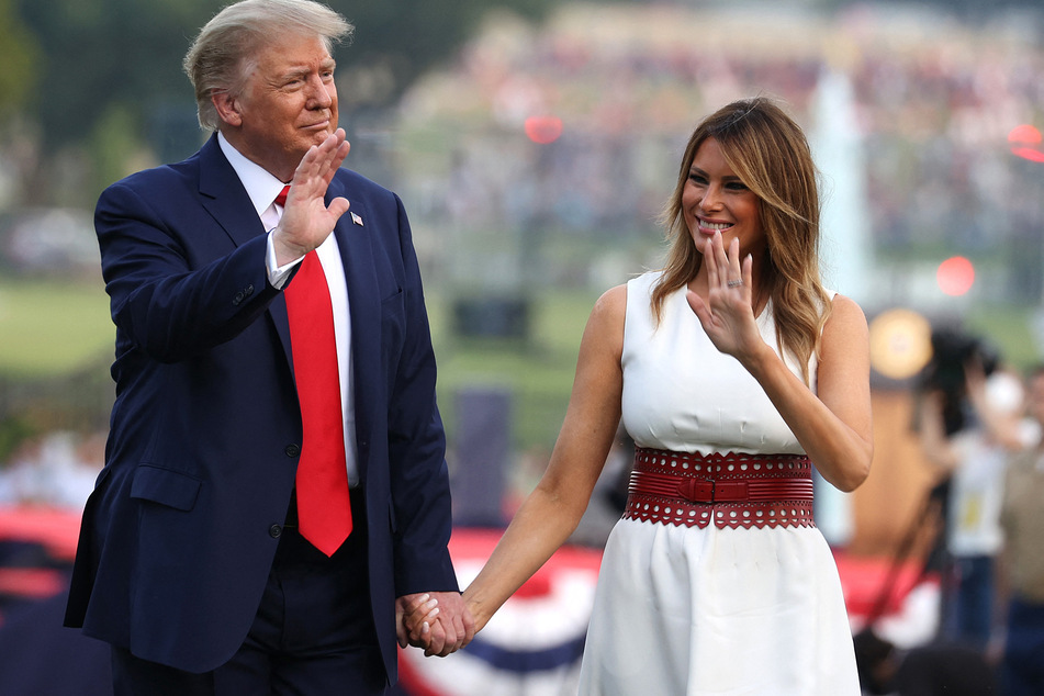 Donald Trump and first lady Melania Trump walking along the South Lawn during an event at the White House in Washington DC on July 04, 2020.