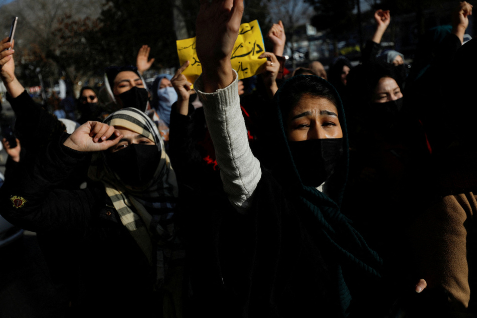 Afghan women chant slogans in protest against the Taliban's closure of universities to women in Kabul, Afghanistan, on December 22, 2022.
