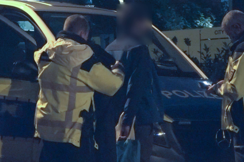 Hier wird eine Person von der Polizei kontrolliert.