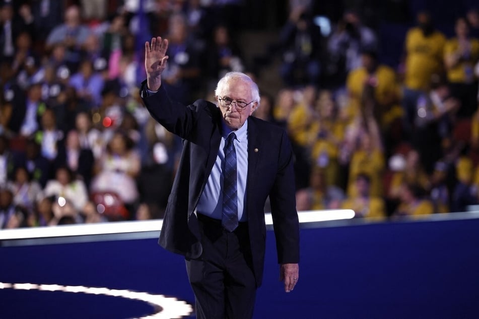 Senator Bernie Sanders waves to the crowd after speaking on stage during the second day of the 2024 Democratic National Convention in Chicago, Illinois.