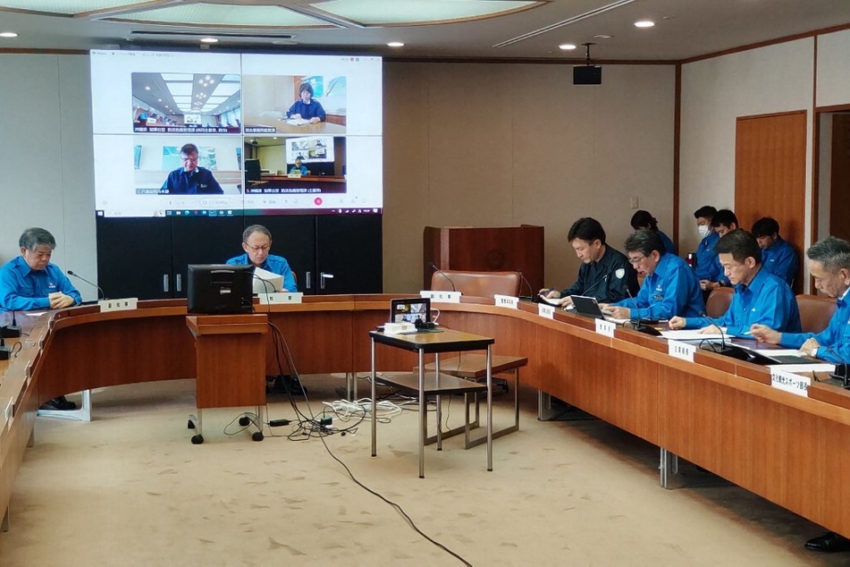 Governor of Okinawa Prefecture Denny Tamaki (top, second l.) attends a disaster control headquarters meeting on April 3, 2024, following a magnitude-7.4 earthquake in Taiwan.