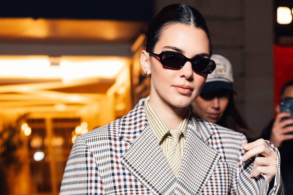 Kendall Jenner kept her risqué 'fit wrapped tightly underneath her chic Maxi coat for New York Fashion Week.