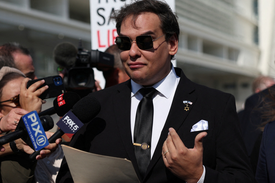 George Santos reads a statement after pleading guilty to criminal corruption charges at Central Islip Federal Courthouse in New York.