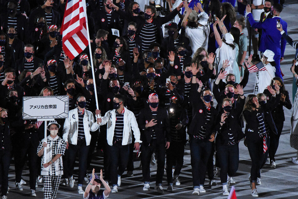 Team USA during the Olympic opening ceremony, led by flagbearers Sue Bird (l.), and Eddy Alvarez.