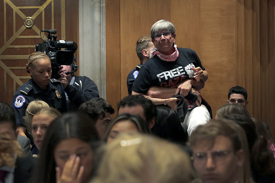 Kathy Gannett, wearing a "Free Gaza" shirt, is removed as Secretary of State Marco Rubio speaks during a Senate Foreign Relations Committee hearing.
